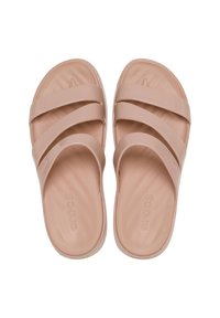 Pale pink rubber slide sandals with three wide straps and contoured footbed, featuring a smooth texture and rounded edges.