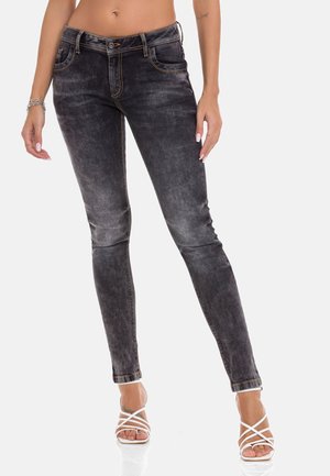 Schwarze Denim-Skinny-Jeans mit einem verblassten Finish, orangefarbener Naht und einem enganliegenden Schnitt. Vorder Taschen und ein Knopfverschluss verbessern das Design.