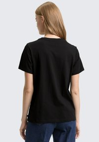 Schwarz, kurzärmeliges T-Shirt mit Rundhalsausschnitt, aus weicher Baumwolle gefertigt, mit einem lässigen Schnitt und geradem Saum.