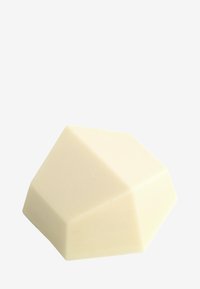 Geometric bar soap in ivory color, smooth texture with angled facets, featuring a multi-sided shape and minimalist design.