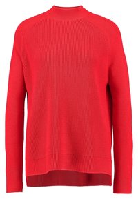Red knit sweater with a high neck, long sleeves, and a ribbed texture. Features a relaxed fit and a longer back hem.