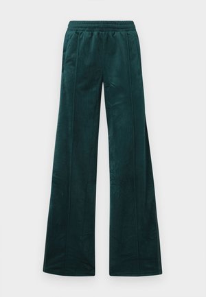 Teal vida byxor med en mjuk sammetstextur, funktioner ett elastiskt midjeband och vertikala sömdetaljer. Inga fickor synliga.