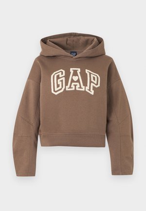 Braunes, kurz geschnittenes Hoodie mit "GAP" in cremefarbenen Buchstaben, das ein Herz in der Mitte des Buchstabens A zeigt, mit langen Ärmeln und einer Kapuze.