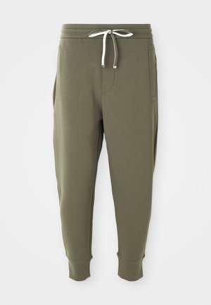 Olive green jogger pants with white drawstring, elastic waistband, side pockets, and ribbed cuffs on a white background.