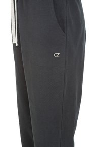 Zwarte joggers van katoen met een elastische tailleband, voorzien van een trekkoord, zijzakken en een klein geborduurd logo.