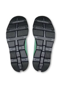Semelles de chaussures avec une surface texturée en caoutchouc, présentant un motif en grille et des accents noirs et verts, conçues pour l'adhérence et la durabilité.