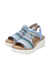 Sandales ouvertes avec un dessus tissé multicolore présentant des nuances de bleu, beige et vert. Semelle épaisse en plateforme blanche avec une finition texturée.