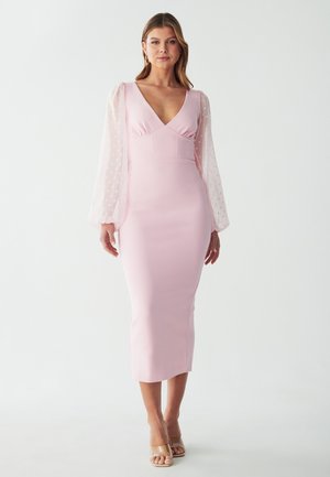 Pink midi dress with a fitted silhouette, deep V-neck, and sheer puff sleeves featuring polka dots. Smooth, textured fabric.