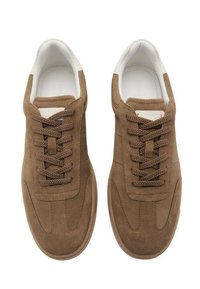 Brown suede sneakers with white accents, featuring round laces, padded tongue, and textured rubber sole. Minimalist design with stitch details.