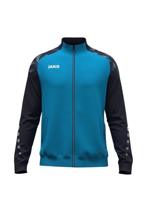 Giacca sportiva blu e nera con cerniera frontale, due tasche laterali e logo bianco "JAKO" sul petto destro e puntini sulle maniche.