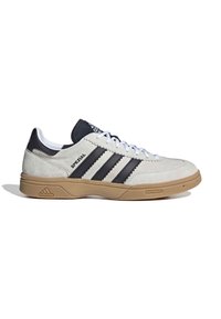 Baskets en daim blanc avec des accents en cuir noir et trois bandes noires. Elles présentent une semelle en gomme caoutchoutée et un logo "Spezial" sur le côté.