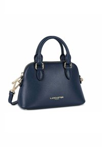 Borsa in pelle blu marina con hardware oro, doppi manici superiori, una tracolla staccabile e logo in rilievo sulla parte anteriore.