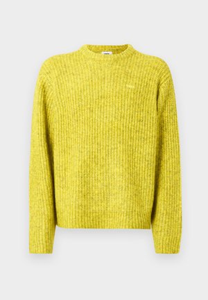 Geel gebreide trui met geribbelde textuur, ronde halslijn en lange mouwen; met een klein logo op de borst.