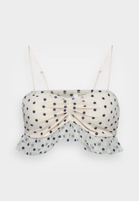 Bralette com padrão de bolinhas, apresentando um tecido bege com bolas azul-marinho, centro franzido e bainha de renda com babados. Alças ajustáveis para melhor ajuste.