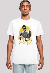 Bílý bavlněný tričko s grafikou maskované postavy v černé a bílé barvě, s nápisem "HOLY SMOKES BATMAN!!!" v žlutém písmu a komiksovými akcenty.