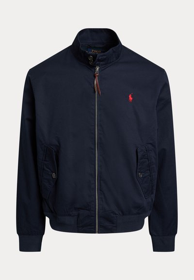 Marineblaue Bomberjacke aus leichtem Stoff, mit einem Reißverschluss, zwei seitlichen Taschen und einem roten gestickten Logo auf der Brust.