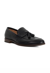 Black leather loafers feature a textured finish, a rounded toe, a decorative tassel accent, and a low stacked heel.