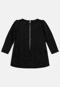 Czarna sukienka z długimi rękawami, z małymi złotymi kropkami, okrągłym dekoltem i zamkiem z tyłu. Lekka, teksturowana tkanina, w kształcie rozkloszowanym.