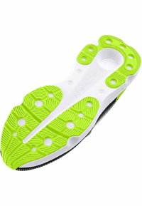Semelle noire avec un intercalaire texturé blanc et des accents en caoutchouc vert vif. Présente des motifs de grip circulaires et ovales pour une meilleure adhérence.