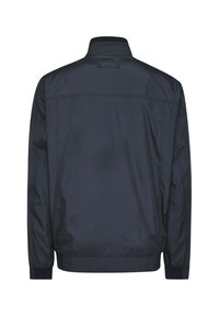 Navy blue, lightweight jacket featuring a stand collar, elastic cuffs, and a smooth texture, designed with a back logo and minimal stitching.