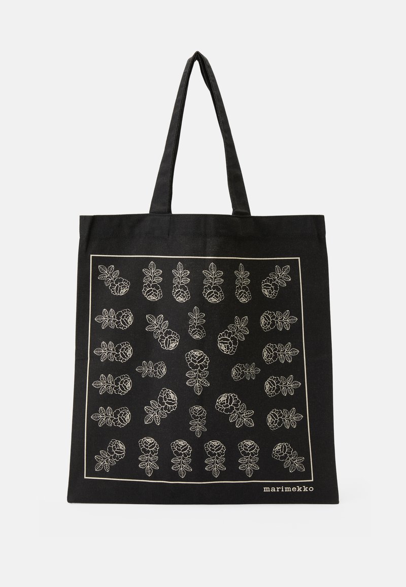 Svart totebag med hvitt blomsterdesign, som har konturer av blomster og blader, laget av slitesterkt stoff, med doble håndtak.