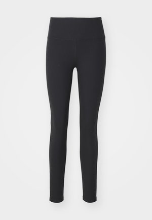 Leggings noirs à côtes avec une taille haute, fabriqués en matériau extensible. Présentent un ajustement serré et une texture lisse, adaptés à diverses activités.