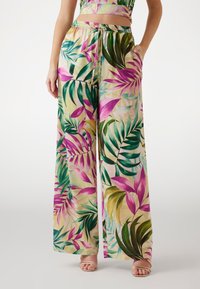 Pantaloni ampi a fiori con vita regolabile. Realizzati in tessuto leggero, presentano vivaci motivi di foglie rosa e verdi.