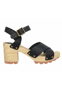 Sandale plateforme strappy en cuir noir avec un talon en bloc de bois, ornée de clous en métal et d'une sangle à boucle, semelle texturée avec des bords festonnés.