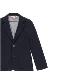 Blazer blu navy realizzato in tessuto testurizzato, con due tasche frontali, colletto a revers e due bottoni. Interno foderato con una tonalità grigia.