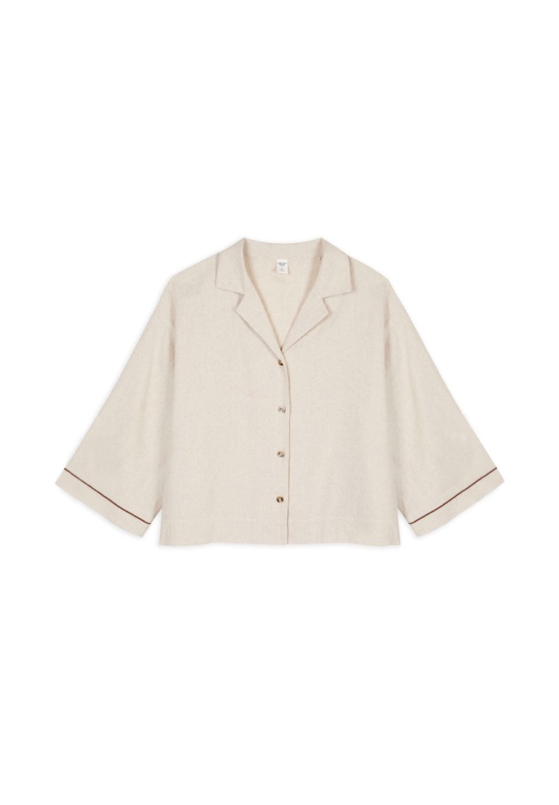 Beige linen cropped blouse with a notch collar, front buttons, and 3/4 sleeves that have brown trim accents on the cuffs.