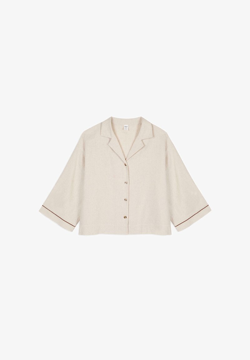 Beige linen cropped blouse with a notch collar, front buttons, and 3/4 sleeves that have brown trim accents on the cuffs.