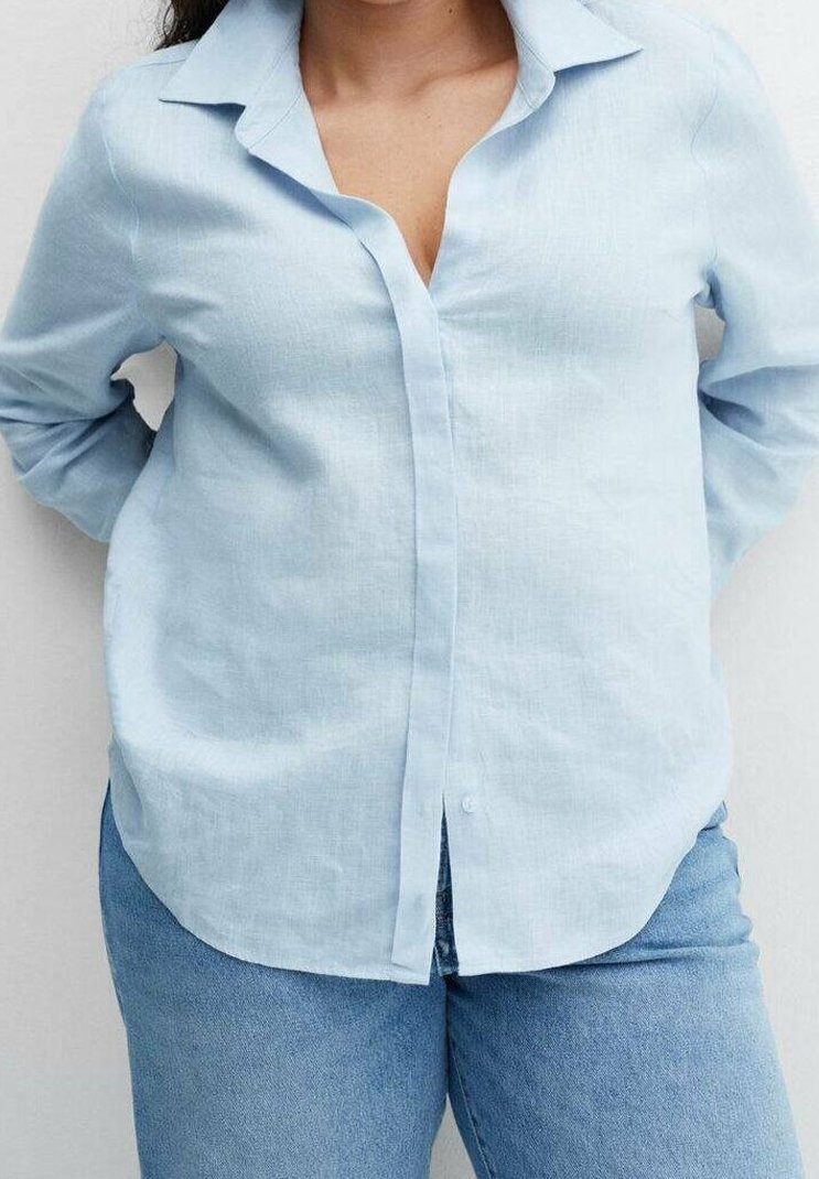 Chemise bleu clair à manches longues, boutonnée, en lin, avec un col et une coupe décontractée ; présente une texture lisse et un subtil éclat.