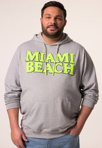 Felpa grigia con un grande logo testurizzato in verde neon "MIAMI BEACH" sul davanti, dotata di cappuccio con cordoncino e tasca frontale.