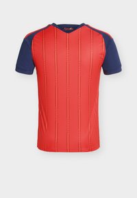 Red sports jersey with navy blue short sleeves, featuring vertical stripes in yellow and a V-neck design. Material appears breathable and textured.
