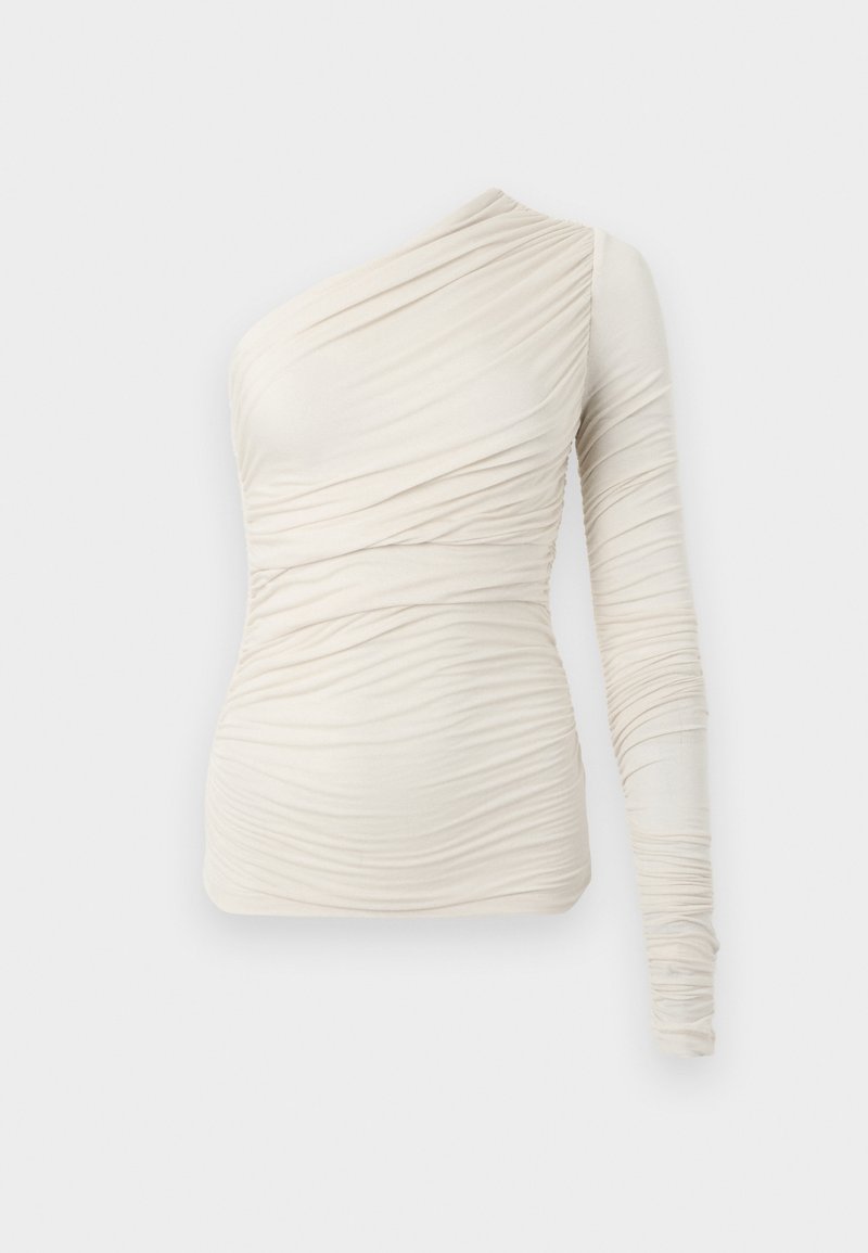 Top crema asimmetrico realizzato in tessuto morbido, con una manica lunga e dettagli arricciati su tutta la superficie. Design semplice e aderente.