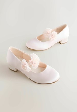 Pantofi de balet din satin roz, cu vârf rotund și toc mic și gros, având două accente florale pe partea interioară a piciorului. Textură netedă și design simplu.