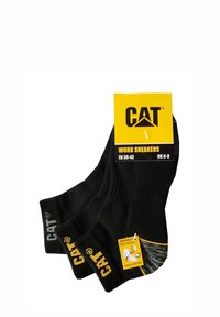 Chaussettes de travail noires avec un design côtelé, talon et orteil renforcés, présentant un logo CAT jaune et une étiquette indiquant la taille EU 39-42, UK 6-9.