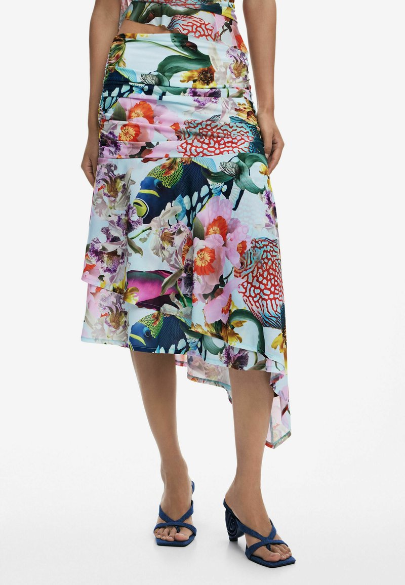 Floral multi-colored asymmetric skirt with layered design, featuring vibrant patterns of flowers and fish on a light blue background.