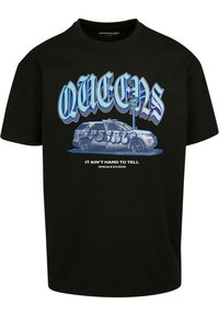 Black cotton t-shirt featuring a graphic of a white SUV with graffiti and stylized text "QUEENS" in blue. Crew neckline and short sleeves.