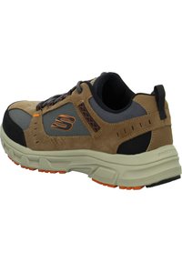 Scarpa da ginnastica marrone e grigia con tomaia in suede texturizzato, pannelli in rete, dettagli arancioni e suola in gomma spessa con battistrada.