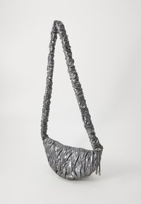 Borsa a tracolla a forma di mezzaluna in metallo argentato, con motivo trapuntato, tracolla regolabile arricciata e dettaglio con cordoncino su uno sfondo semplice.