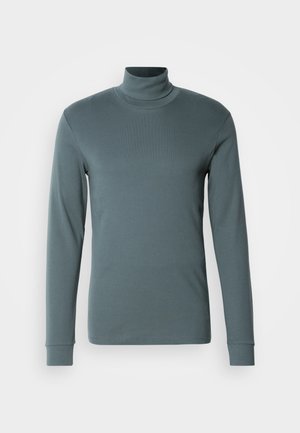 Maglietta a maniche lunghe a dolcevita in verde teal smorzato, realizzata in un morbido tessuto elasticizzato. Presenta una silhouette aderente e polsini a coste.