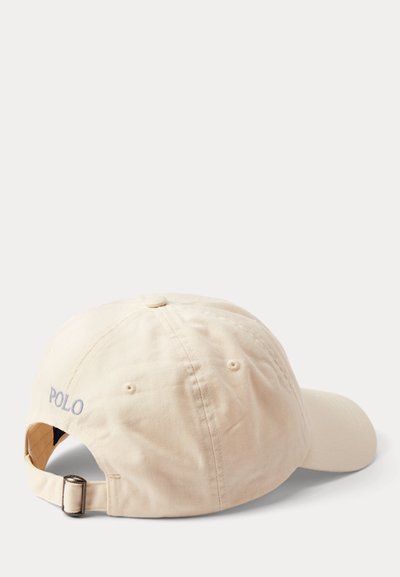Smėlio spalvos reguliuojamas beisbolo kepuraitė su metaline sagtimi ir pilkais siuvinėjimais „POLO“ gale, rodoma iš galinės šoninės pusės baltame fone.