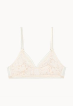Bralette en dentelle dans un doux pêche, avec des bonnets triangulaires, des bretelles fines réglables et des bords festonnés ornés d'un motif étoilé subtil.