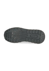 Semelle d'une chaussure noire avec un motif de grip texturé et la marque "Maxx" au centre.