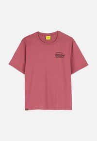 T-shirt à manches courtes de couleur rose muted, fabriqué en coton, avec un logo Oxbow noir sur la poitrine et un col rond.