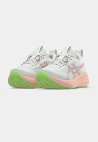 Lightweight athletic shoes with a mesh upper in white and pink accents, featuring a green rubber sole and cushioned design.