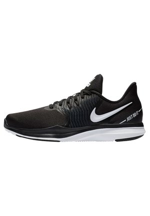 Chaussure de course Nike noire avec semelle blanche, logo Nike blanc et texte "Just Do It" sur le côté, vue de l'extérieur.