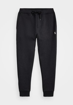 Sorte sweatpants laget av mykt materiale, med elastisk midjebånd og snøring, sidelommer og en liten brodert logo.