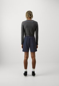 GAP Pantaloni de trening - tapestry navy